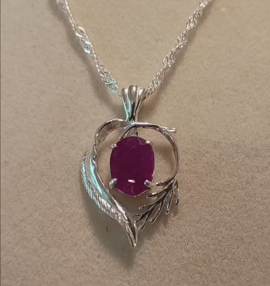 Ruby in heart & feathers setting