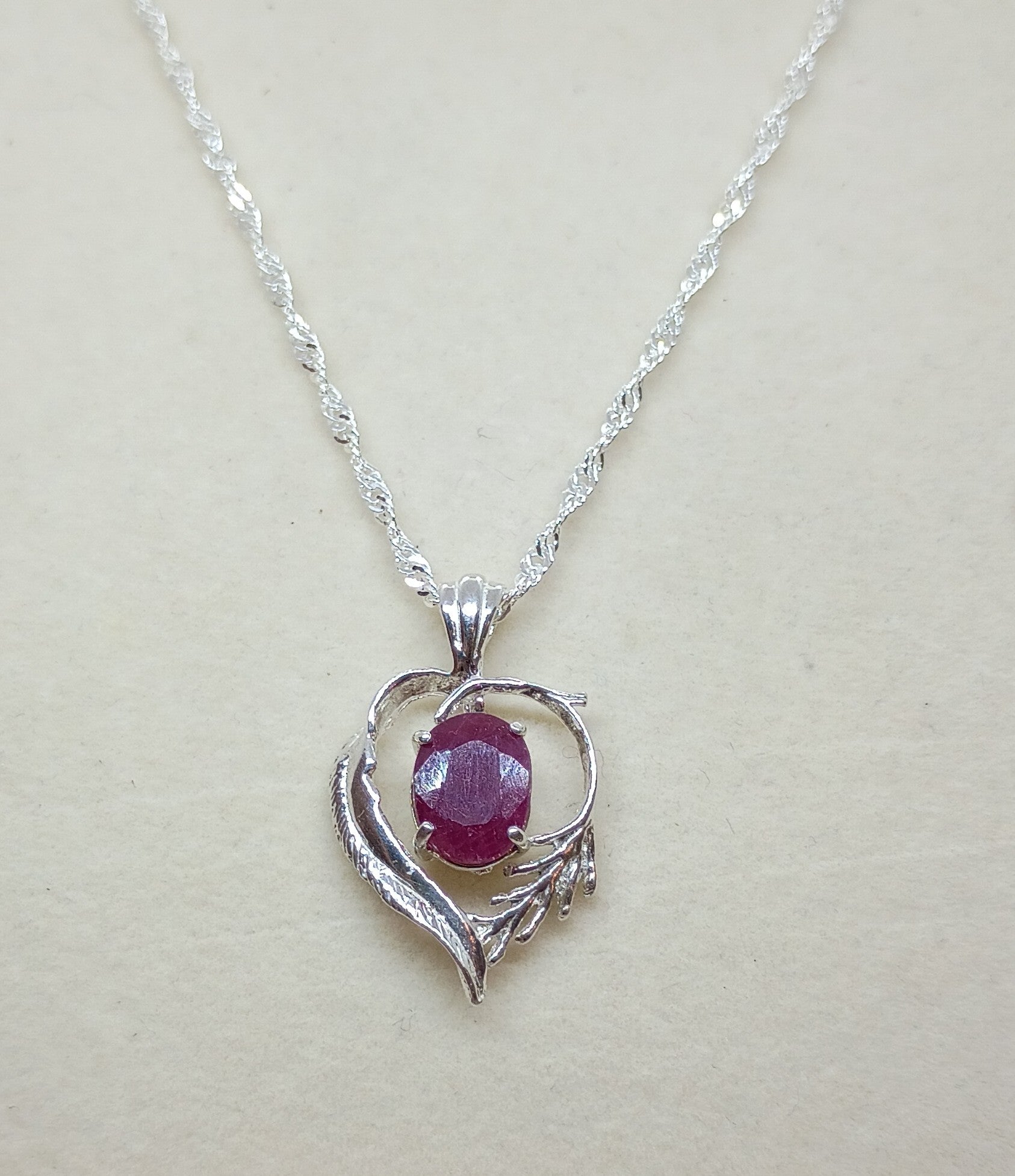 Ruby in heart & feathers setting